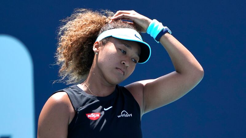 FILE - Naomi Osaka, of Japan, reacts during her match against Maria Sakkari, of Greece, in the...
