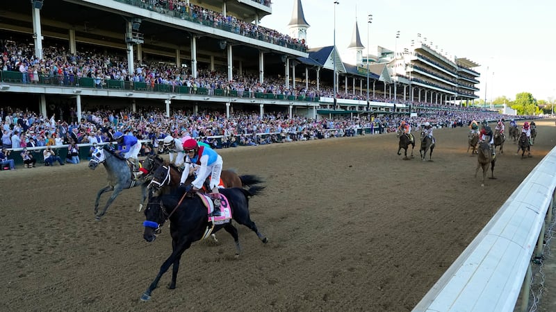 John Velazquez riding Medina Spirit leads Florent Geroux on Mandaloun, Flavien Prat riding Hot...